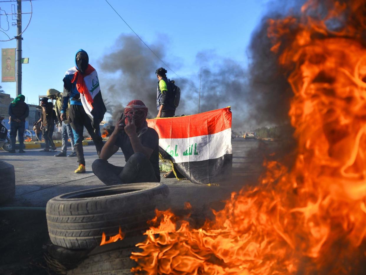 Iraqi demonstrators block a road with burning tyres in the central shrine city of Najaf, on 5 January 2020, to protest turning the country into an arena for US-Iran conflicts: AFP/Getty