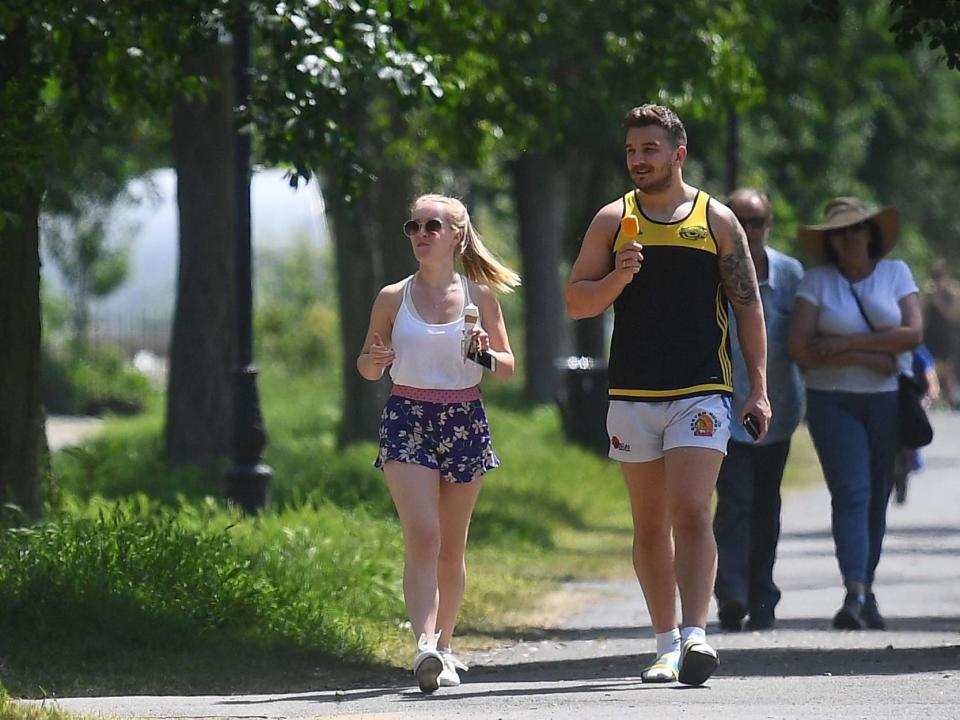 People enjoy the hot weather on Clapham Common, London, as people are being reminded to practise social distancing during the good weather and the relaxation of lockdown restrictions: PA