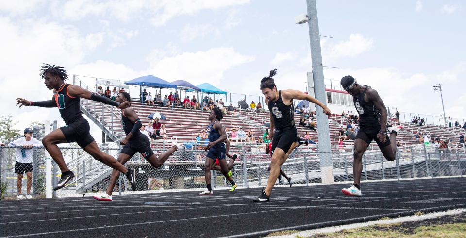 Dunbar’s Tawaski Abrams, left, wins the 100 at the FHSAA Class 3A District-12 track and field meet at South Fort Myers High School on Saturday, April 23, 2022. Dunbar’s Barry White, second from left was second.  