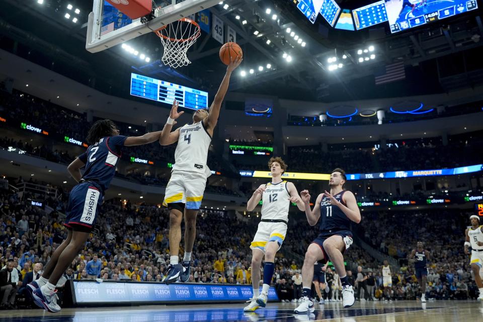Marquette's Stevie Mitchell shoots past UConn's Tristen Newton during the first half of an NCAA college basketball game Wednesday, March 6, 2024, in Milwaukee. (AP Photo/Morry Gash)