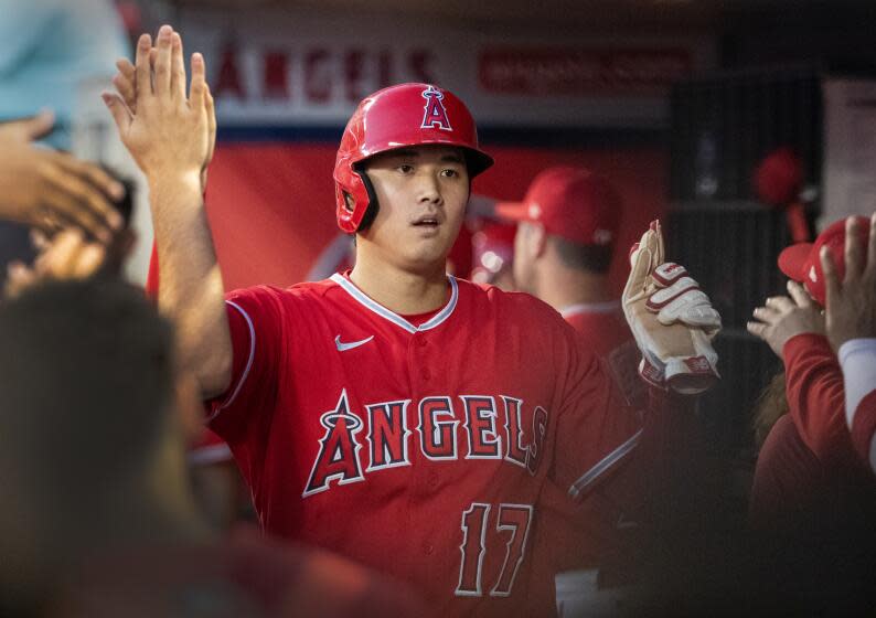 Anaheim, CA - July 18: Angeles players celebrate two-way player and designated hitter Shohei Ohtani.