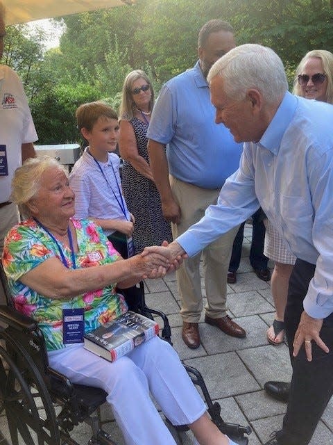 Former Vice President Mike Pence greets Claire Ignacio, 91, at a presidential campaign event in Hudson, N.H., on July 19, 2023.