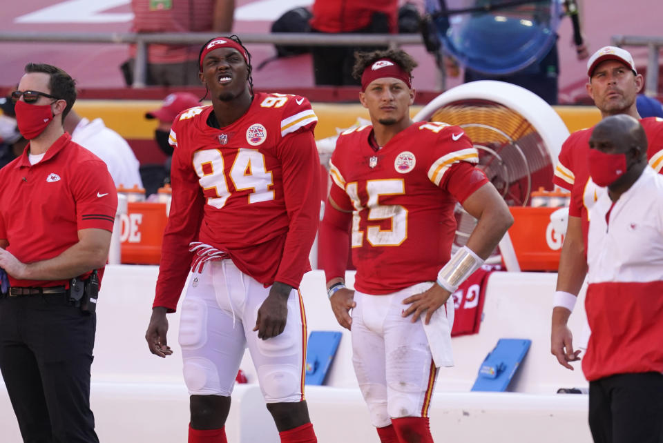 Kansas City Chiefs defensive end Taco Charlton (94) and quarterback Patrick Mahomes (15) watch from the bench during the second half of an NFL football game against the Las Vegas Raiders, Sunday, Oct. 11, 2020, in Kansas City. The Raiders won 40-32. (AP Photo/Charlie Riedel)