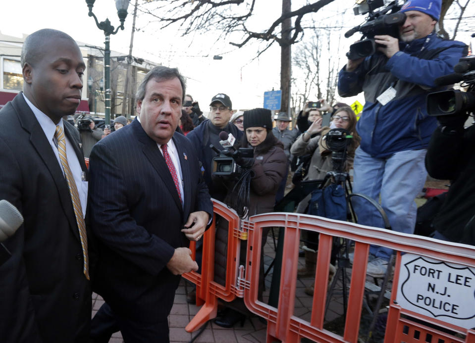 FILE - In this Jan. 9, 2014 file photo, New Jersey Gov. Chris Christie, second left, arrives at Fort Lee, N.J., City Hall. Christie traveled to Fort Lee to apologize in person to Mayor Mark Sokolich. Many people have known little about Fort Lee until a political scandal centering on Christie enveloped the borough. Now for residents of the New York City bedroom community defined by both a feisty pride and frustration over the mixed blessings of proximity to the George Washington Bridge, the scandal is the reminder they did not need of how the bridge dictates the rhythm of everyday life. (AP Photo/Richard Drew, File)