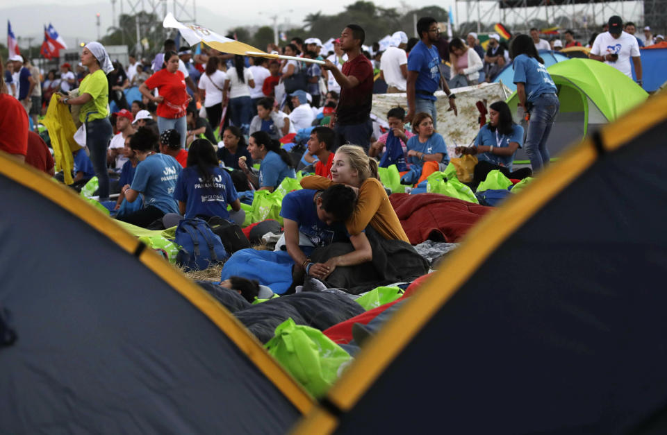 Youth wait for the arrival of Pope Francis at the metro park Campo San Juan Pablo II in Panama City, Sunday, Jan. 27, 2019, to celebrate an early morning Mass, on his final day of his five-day visit to the Central American country. (AP Photo/Alessandra Tarantino)