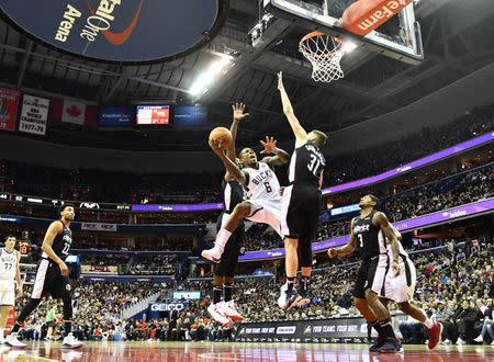 Jan 11, 2019; Washington, DC, USA; Milwaukee Bucks guard Eric Bledsoe (6) shoots over Washington Wizards guard Tomas Satoransky (31) during the second half at Capital One Arena. Mandatory Credit: Brad Mills-USA TODAY Sports