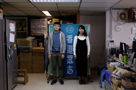 Student activists Isaac Cheng and Agnes Chow (R) pose for photo, at Demosisto party's office in Hong Kong, China December 8, 2017. REUTERS/Tyrone Siu