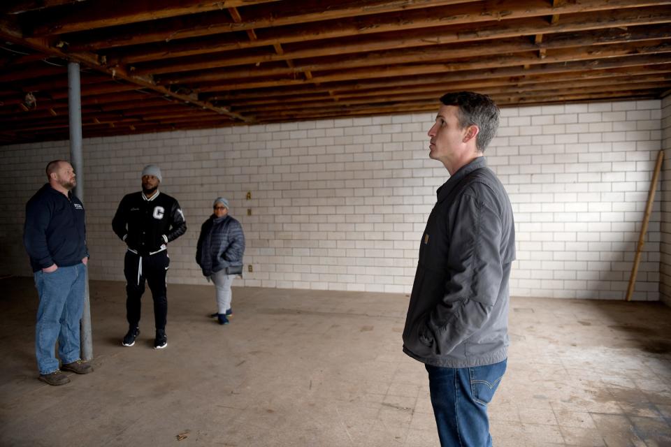 Canton For All People Managing Director Mike Farmer, Community Organizer Gino Hayes, Housing Navigator Cynthia Hammond and Executive Director Don Ackerman stand inside what will be Shorb Neighborhood Market and Resource Center, part of continuing work by the nonprofit to revitalize the greater Shorb area.