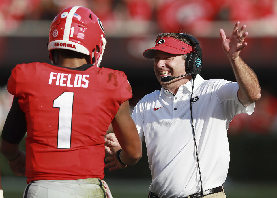 Georgia head coach Kirby Smart celebrates with quarterback Justin Fields after his first of two second half touchdown runs against Tennessee in an NCAA college football game Saturday, Sept 29, 2018, in Athens. (Curtis Compton/Atlanta Journal-Constitution via AP)