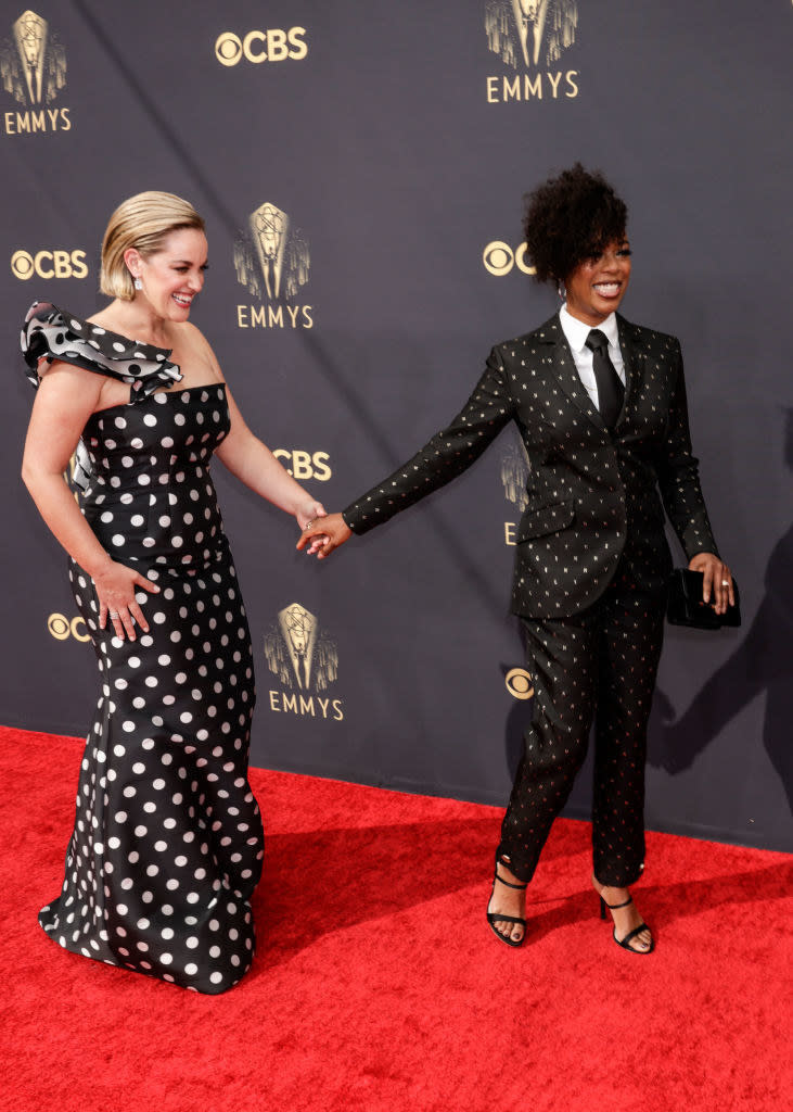 dressed in matching black outfits with white polka dots, Lauren and Samira walk the carpet hand-in-hand