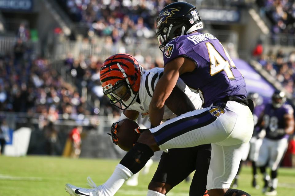 Oct 24, 2021; Baltimore, Maryland, USA; Cincinnati Bengals wide receiver Ja'Marr Chase (1) catches a pass in front of Baltimore Ravens cornerback Marlon Humphrey (44) during the second half  at M&T Bank Stadium.