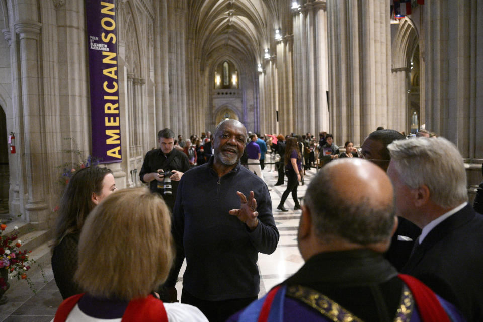 Artist Kerry James Marshall, center, speaks to attendees after an unveiling and dedication ceremony at the Washington National Cathedral for the new stained-glass windows with a theme of racial justice, Saturday, Sept. 23, 2023, in Washington. The new windows, titled “Now and Forever," are based on a design by Marshall. Marshall, who was born in Birmingham in 1955, invited anyone viewing the new windows, or other artworks inspired by social justice, “to imagine oneself as a subject and an author of a never-ending story is that is still yet to be told.” (AP Photo/Nick Wass)