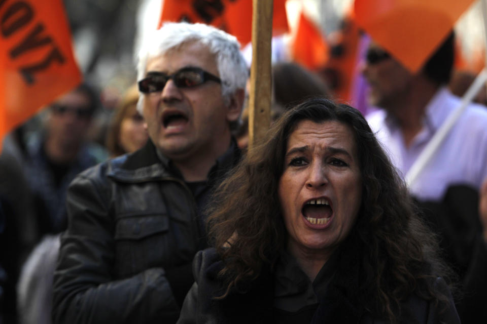 Protesters chant anti-austerity slogans during a rally in the northern Greek port city of Thessaloniki, on Wednesday, March 19, 2014. Greek civil servants, including hospital and teaching staff, have started a two-day strike against austerity measures imposed under the debt-mired country's international bailout commitment.(AP Photo/Nikolas Giakoumidis)