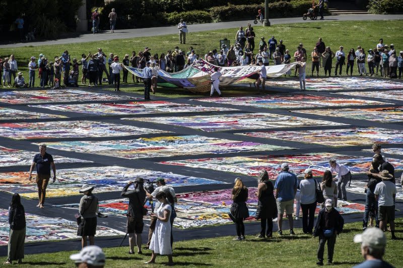 Volunteers help lay out the AIDS Memorial Quilt on its 35th anniversary at San Francisco's Robin Williams meadow in June 2022 in Golden Gate Park, where 3,000 panels of the quilt were displayed, each dedicated to a person who died of AIDS. File Photo By Terry Schmitt/UPI