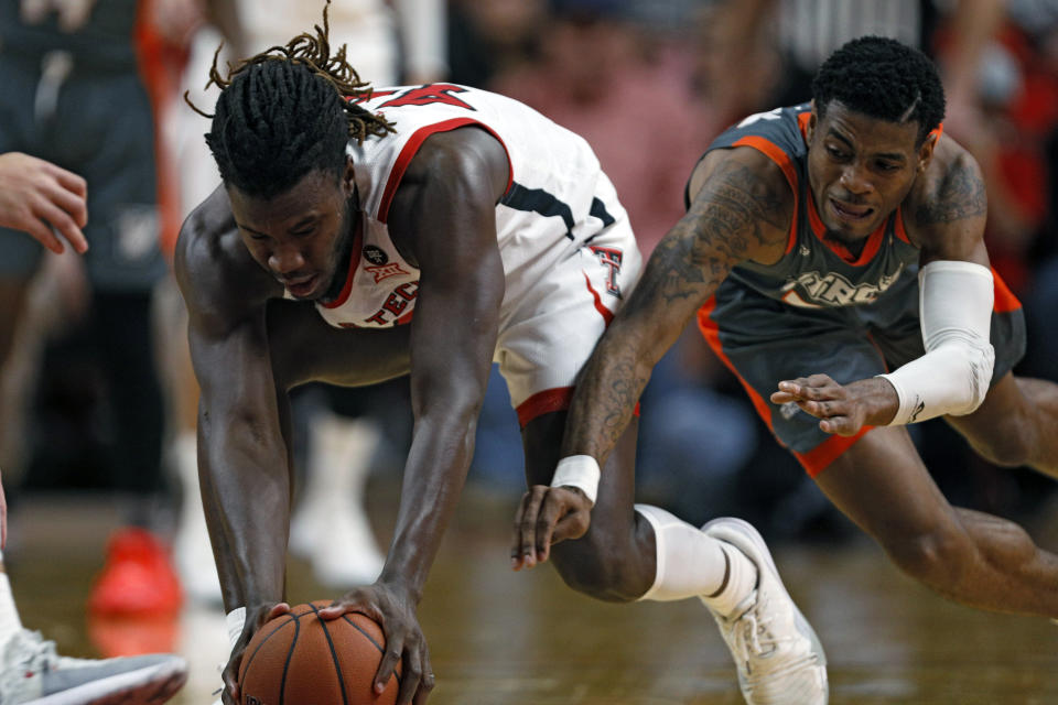 Texas Tech's Chris Clarke (44) and Texas-Rio Grande Valley's Jordan Jackson (22) dive for the ball during the second half of an NCAA college basketball game Saturday, Dec. 21, 2019, in Lubbock, Texas. (AP Photo/Brad Tollefson)