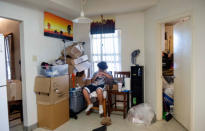 FILE PHOTO: Sincere Bell, 12, sits in his home surrounded by moving boxes at the army base housing allocated to his family in Fort Hood, Texas, U.S. May 16, 2019. Leanne Bell, 39, and her husband, Spc. Tevin Mosley, 26, say they are vacating the home immediately after Mosley's military service contract expires in May. The family says they have experienced severe breathing issues, rashes, depression and hair loss, they believe is attributed to a mold infestation since moving into the home 3 years ago. REUTERS/Amanda Voisard