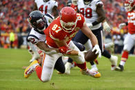 Kansas City Chiefs tight end Travis Kelce (87) scores a touchdown against Houston Texans cornerback Lonnie Johnson Jr. (32) during the first half of an NFL divisional playoff football game, in Kansas City, Mo., Sunday, Jan. 12, 2020. (AP Photo/Ed Zurga)