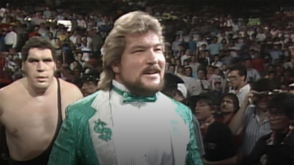 Ted Dibiase and Andre the Giant heading into the ring.