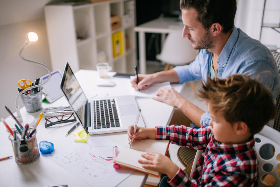 Little boy spending time in his dad's office