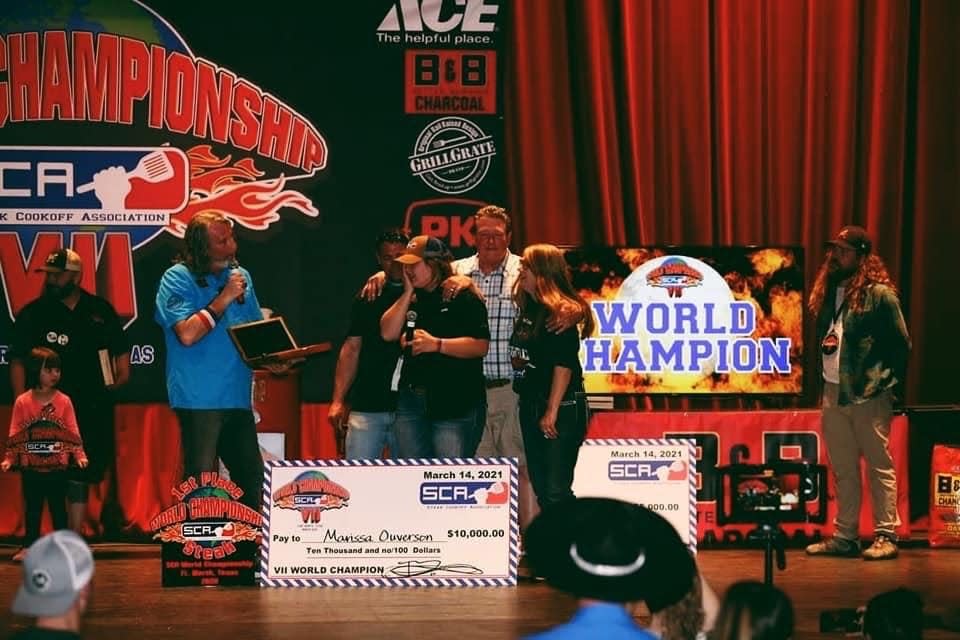 Iowa State student Marissa Ouverson accepts her award alongside her parents, Gregg and Kim Ouverson, in March 2021 as the 2020 Steak Cookoff Association's world champion.