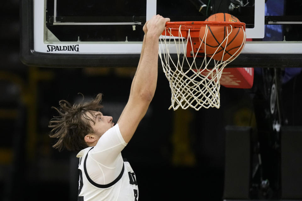 Iowa forward Owen Freeman (32) dunks the ball during the first half of an NCAA college basketball game against Minnesota, Sunday, Feb. 11, 2024, in Iowa City, Iowa. (AP Photo/Charlie Neibergall)