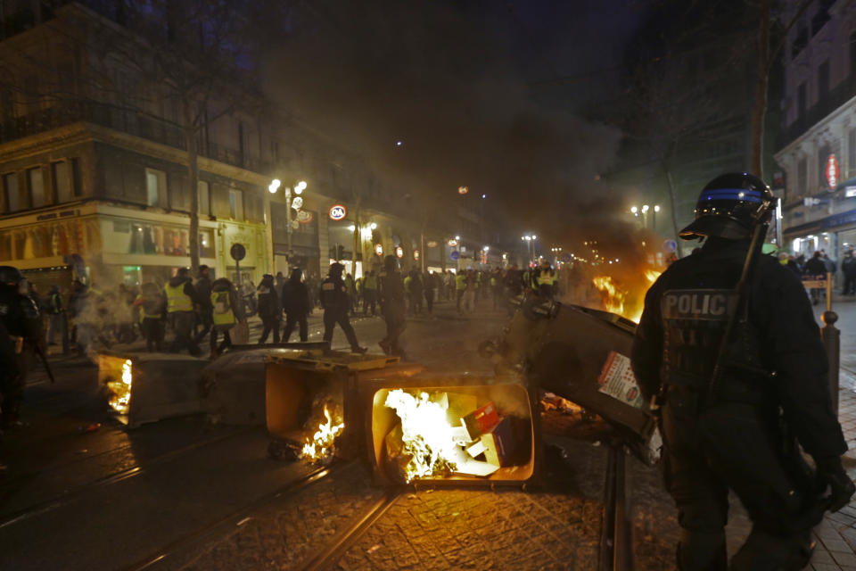 French riot police take positions in the city center during a yellow vest demonstration in Marseille, southern France, Saturday, Jan. 12, 2019. The French Interior Ministry says about 32,000 people have turned out in yellow vest demonstrations across France, including 8,000 in Paris, where scuffles broke out between protesters and police. (AP Photo/Claude Paris)