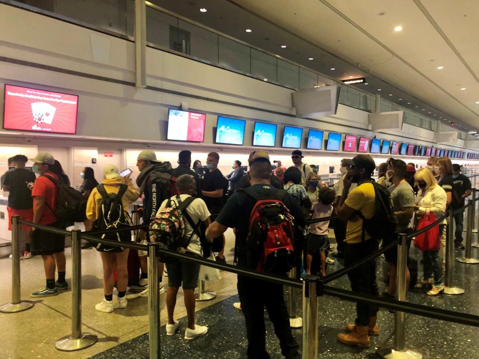 Spirit Airlines passengers with canceled flights at McCarran International Airport in Las Vegas wait in line to be rebooked on Thursday, Aug. 5th