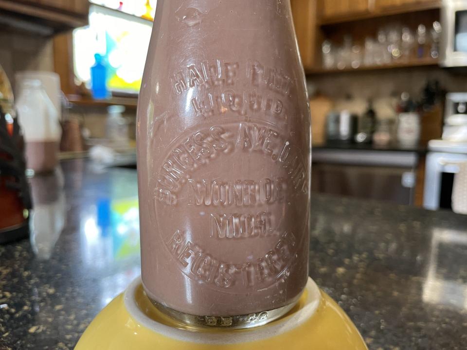 Chocolate milk fills an original bottle from the dairy. The inscription says Borgess Avenue Dairy.