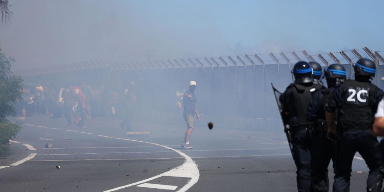 French police officers face demonstrators in Le Port on March 1, 2020, as people protest against the arrival of the passengers of the Sun Princess cruise ship on the Indian Ocean island of La Reunion without having their temperature checked. (Photo by Richard BOUHET / AFP) (Photo by RICHARD BOUHET/AFP via Getty Images)