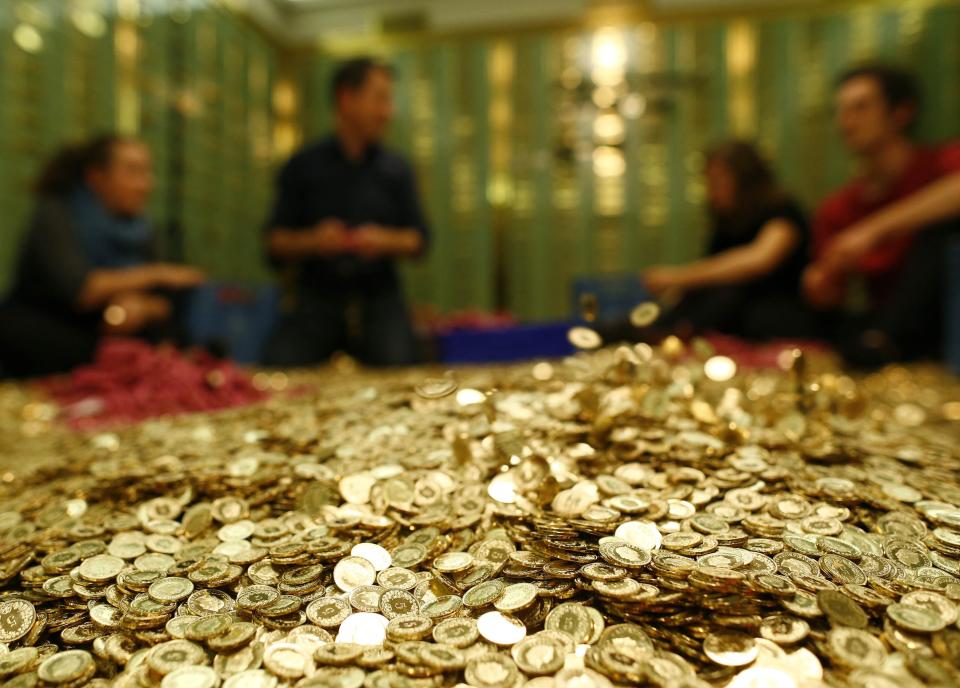 Committee members for 'Grundeinkommen' open rolls of five cent coins in the old vault of the former Schweizerische Volksbank in Basel