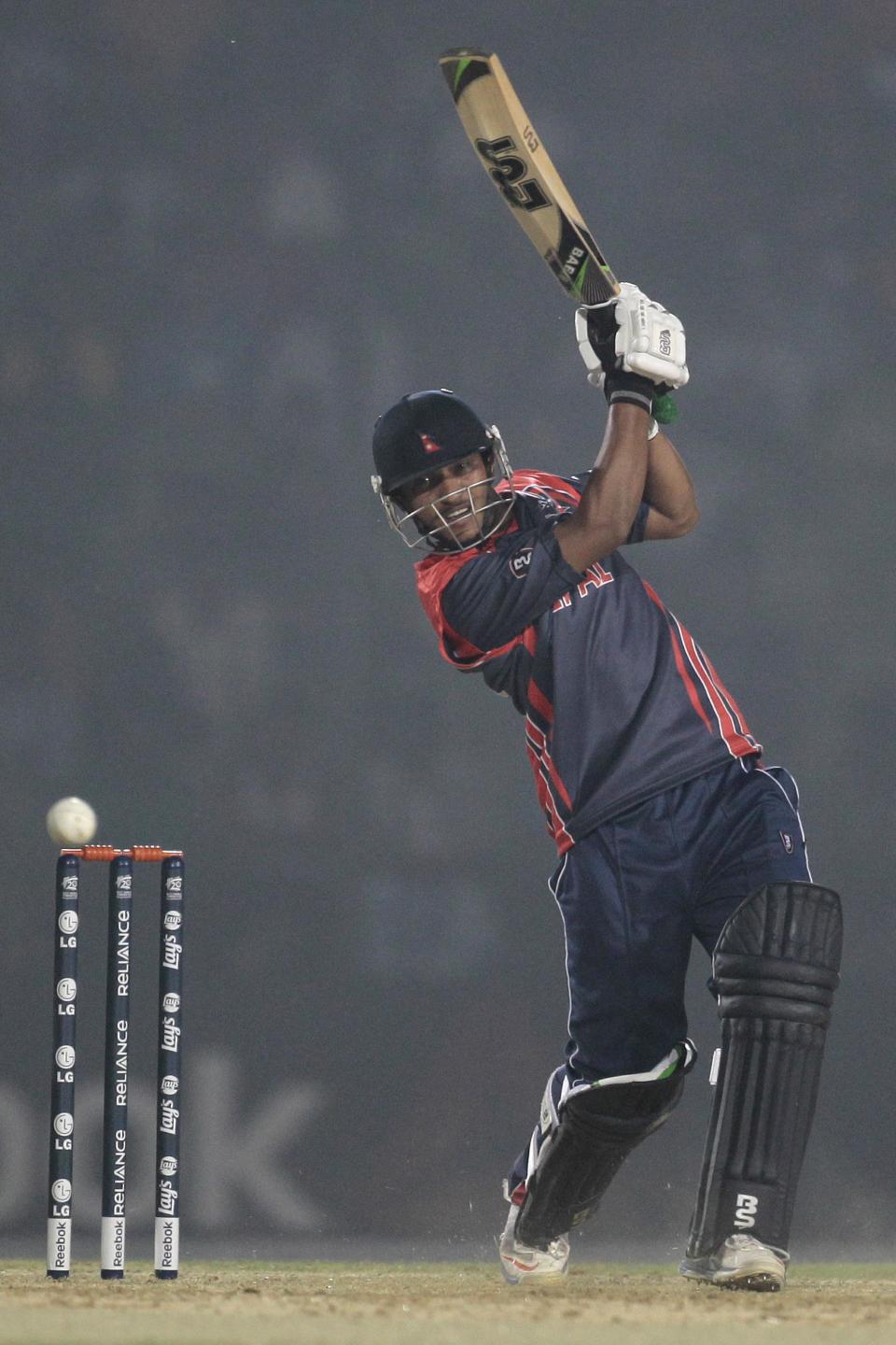 Nepal’s Binod Bhandari plays a shot during a warm-up cricket match against Ireland ahead of the Twenty20 World Cup Cricket in Fatullah, near Dhaka, Bangladesh, Wednesday, March 12, 2014. (AP Photo/A.M. Ahad)