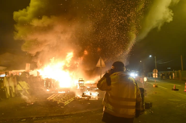 Barricades by "yellow vest" protestors, like this one of an oil terminal in northwestern France, have caused business activity to contract, according to a leading survey