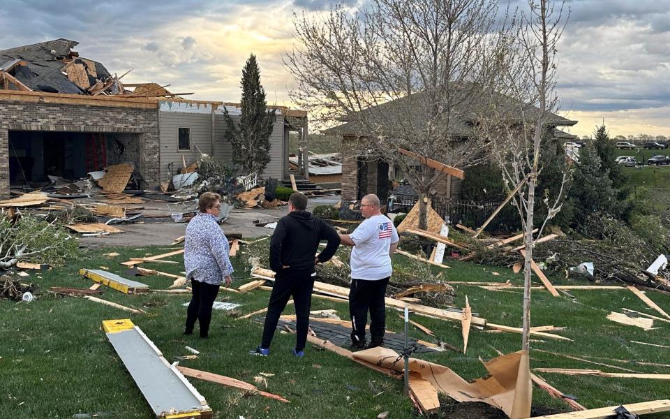 Residents discuss the damage in their neighbourhood of Bennington, northwest of Omaha