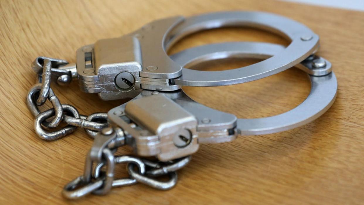 <div>FILE - Handcuffs sitting on a table.</div> <strong>(Bernd Wüstneck/picture alliance via Getty Images.)</strong>