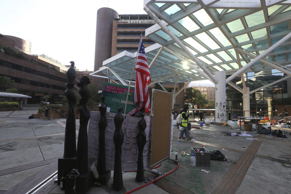 Journalist walk at the campus of the Polytechnic University in Hong Kong, Thursday, Nov. 21, 2019. A small group of protesters refused to leave Hong Kong Polytechnic University, the remnants of hundreds who took over the campus for several days. (AP Photo/Achmad Ibrahim)