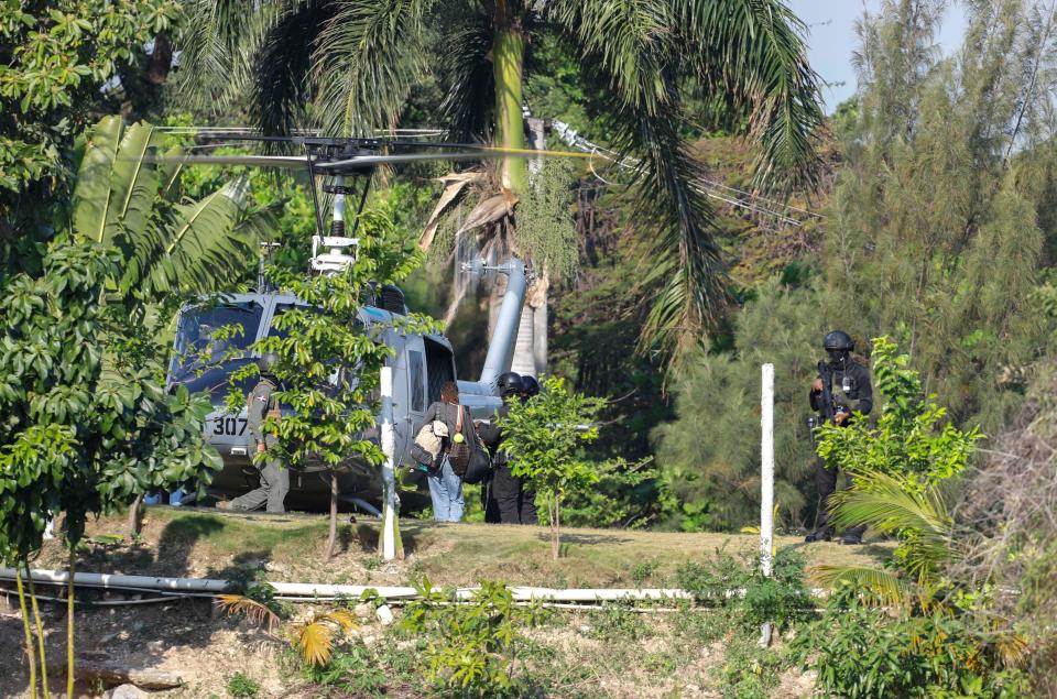 A military helicopter lands to evacuate personnel at the Dominican embassy in Port-au-Prince, Haiti, Thursday, March 21, 2024. (AP Photo/Odelyn Joseph)