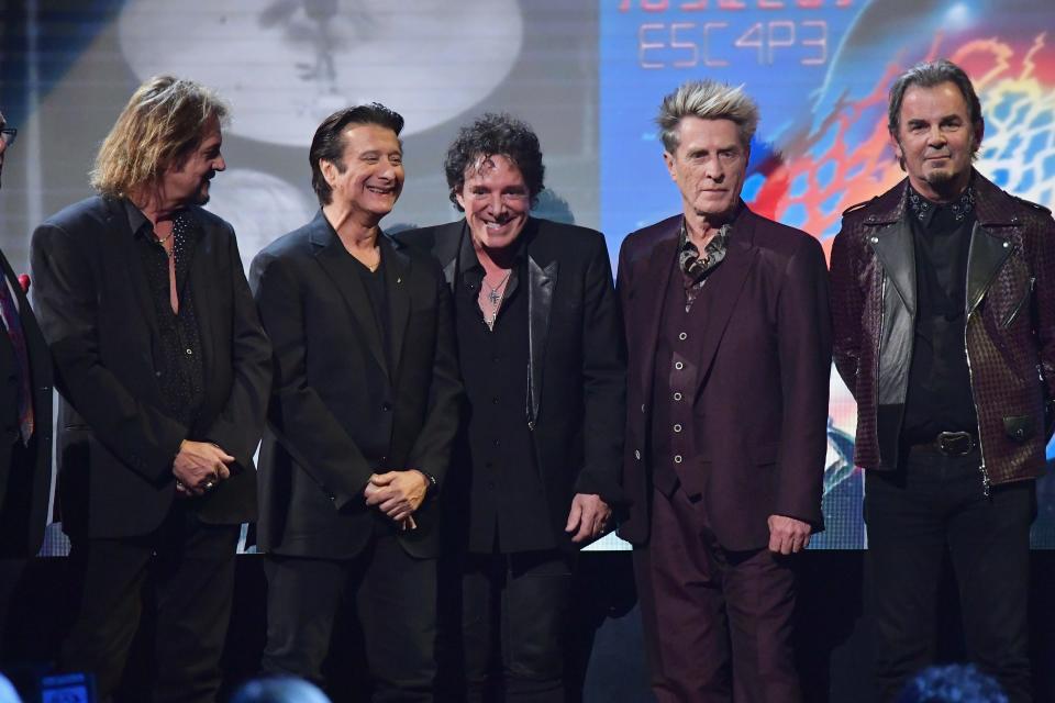 Gregg Rolie, left, Steve Perry, Neal Schon, Ross Valory and Jonathan Cain of Journey speak at the Rock and Roll Hall of Fame induction ceremony on April 7, 2017.