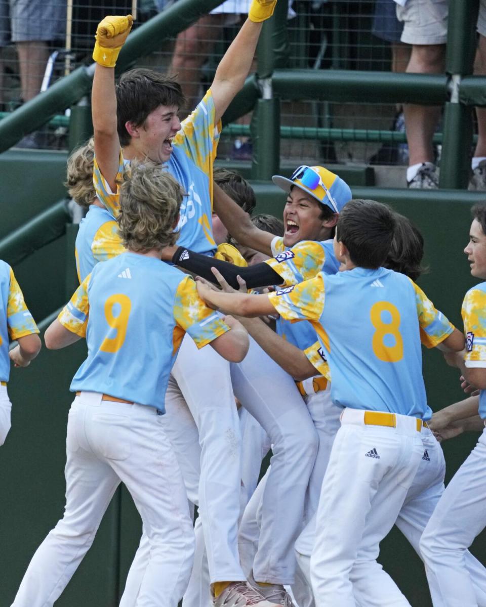 Young ball player lifts up one of their own.