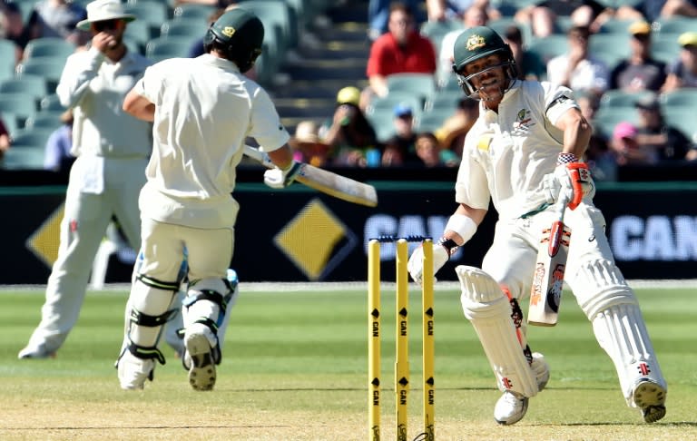 Australia's batsmen David Warner (R) and Joe Burns during the third day of the day-night Test against New Zealand on November 29, 2015