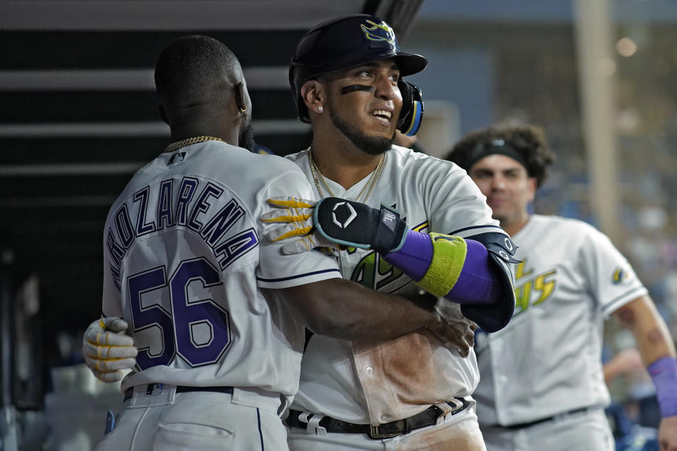 Tampa Bay Rays' Isaac Paredes hugs Randy Arozarena (56) in the dugout after Paredes hit a solo home run off Seattle Mariners relief pitcher Dominic Leone during the eighth inning of a baseball game Friday, Sept. 8, 2023, in St. Petersburg, Fla. (AP Photo/Chris O'Meara)