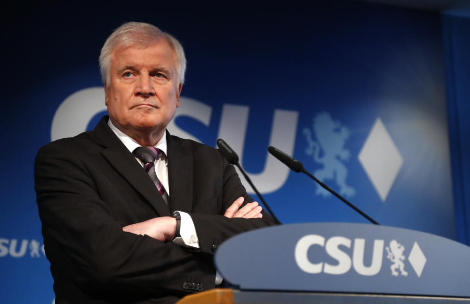 FILE - In this Oct. 15, 2018 file photo German Interior Minister and CSU chairman Horst Seehofer attends a press conference at the headquarters of the Christian Social Union, CSU, in Munich, Germany. Germany's top security official, who has frequently criticized Chancellor Angela Merkel's migrant policy, is reportedly planning to quit his post in government. German news agency dpa quoted multiple unnamed party officials as saying Horst Seehofer told a meeting of the Christian Social Union on Sunday that he plans to relinquish its leadership and his role as interior minister in Merkel's government. (AP Photo/Matthias Schrader, file)