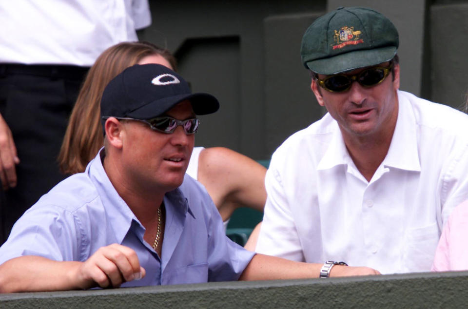  Australian cricket captain Steve Waugh and Shane Warne watch on as Patrick Rafter plays at Wimbledon.