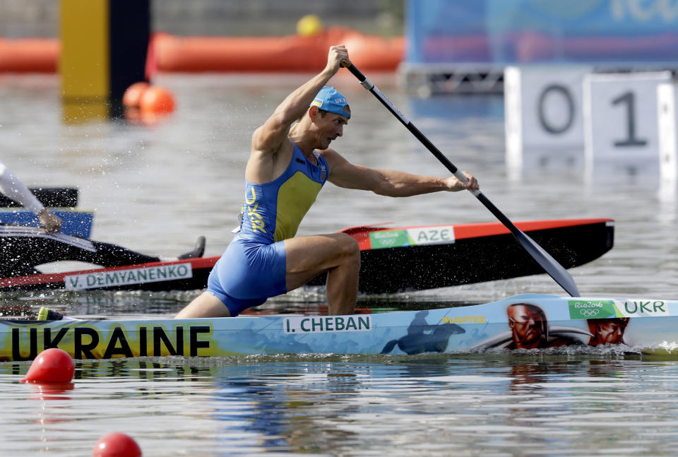 FILE - Ukraine's Yuri Cheban paddles for gold during the men's canoe single 200m final during the 2016 Summer Olympics in Rio de Janeiro, on Aug. 18, 2016. Cheban, one of Ukraine's most decorated Olympians, told The Associated Press in an email exchange Wednesday, Nov. 30, 2022, that he is auctioning his medals — two golds and a bronze — in hopes of raising a six-figure donation to contribute to the war effort in his native land. (AP Photo/Andre Penner, File)