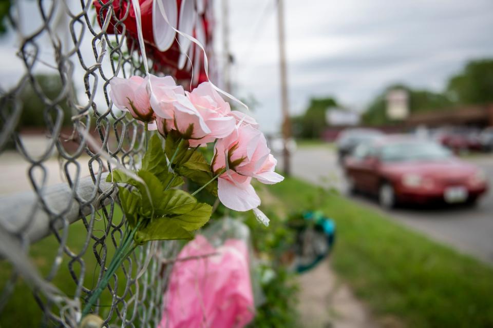 A makeshift memorial for 14-year-old Emma Cardenas near the section of East University Avenue in Des Moines where she died in a hit-and-run accident.