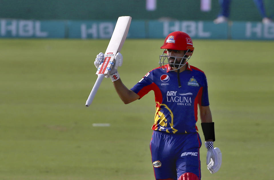 Karachi Kings' Babar Azam raises bat to celebrates after scoring fifty during a Pakistan Super League T20 cricket match between Karachi Kings and Multan Sultans at the National Stadium, in Karachi, Pakistan, Saturday, Feb. 27, 2021. (AP Photo/Fareed Khan)