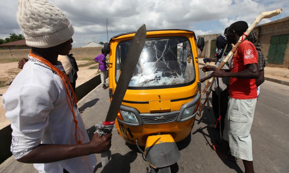 Vigilantes of the Civilian Joint Task Force form a checkpoint on the street in Maiduguri, Nigeria. 