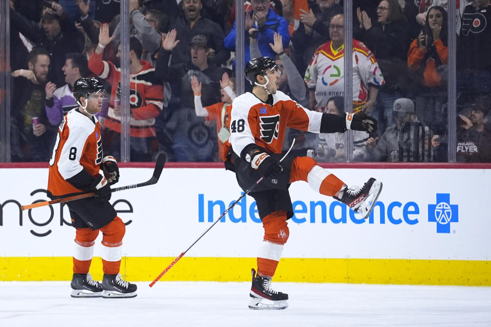Philadelphia Flyers' Morgan Frost, right, celebrates past Cam York after scoring a goal during the first period of an NHL hockey game against the Winnipeg Jets, Thursday, Feb. 8, 2024, in Philadelphia. (AP Photo/Matt Slocum)