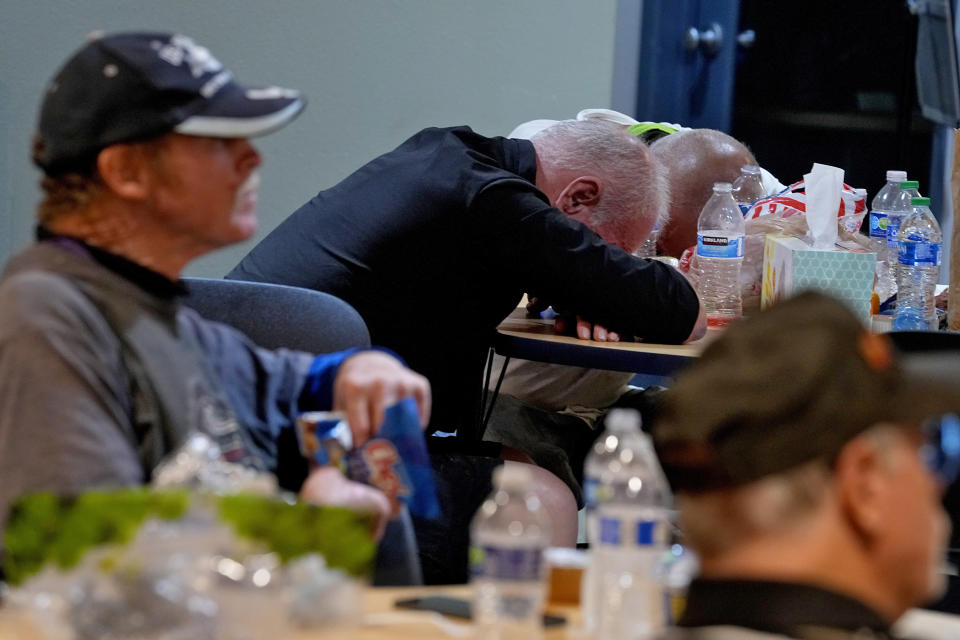 Men who are homeless watch a movie, hydrate and rest inside the Justa Center, a day cooling center for homeless people 55 years and older, Friday, July 14, 2023, in downtown Phoenix. (AP Photo/Matt York)