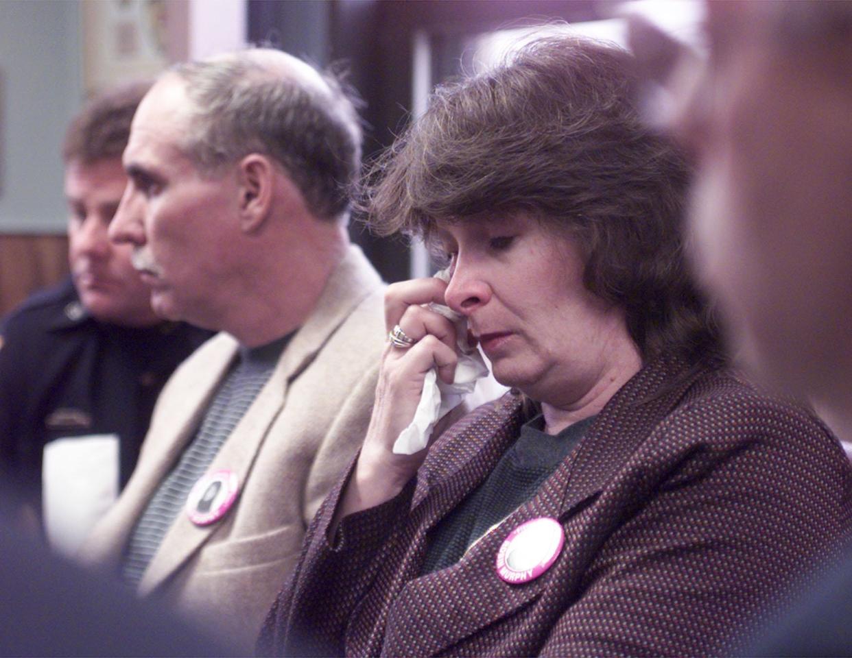 Judith Murphy, mother of Robin Murphy, wipes a tear from her eye during a press conference at the Putnam County Office Building on April 9, 1999. The county was still determined to find the woman after four years. At left is husband Brian Murphy.