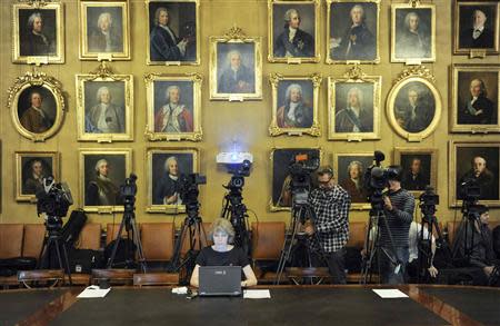 Media representatives wait for the announcement of the winners of the 2013 Nobel Prize in Physics at the Royal Swedish Academy of Sciences in Stockholm October 8, 2013. REUTERS/Erik Martensson/TT News Agency